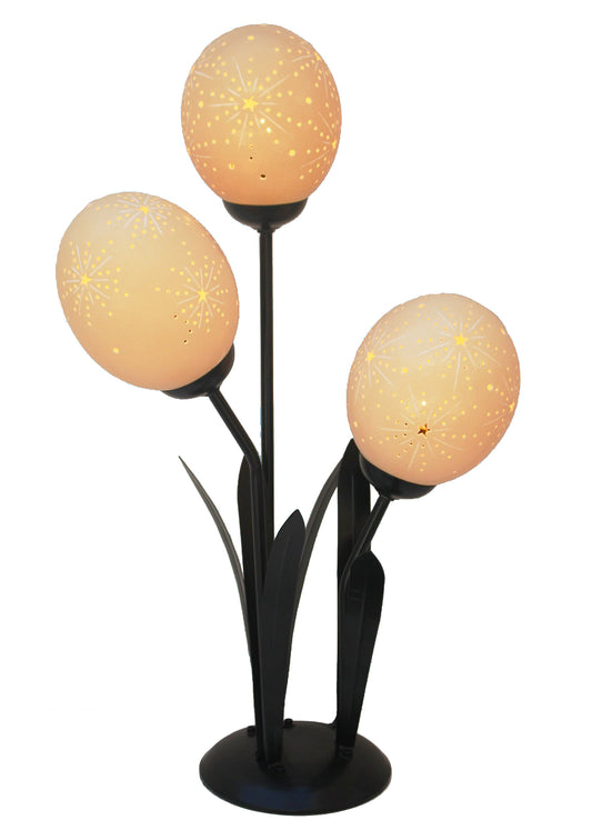 Starburst etched ostrich eggshell set on a flower lamp stand