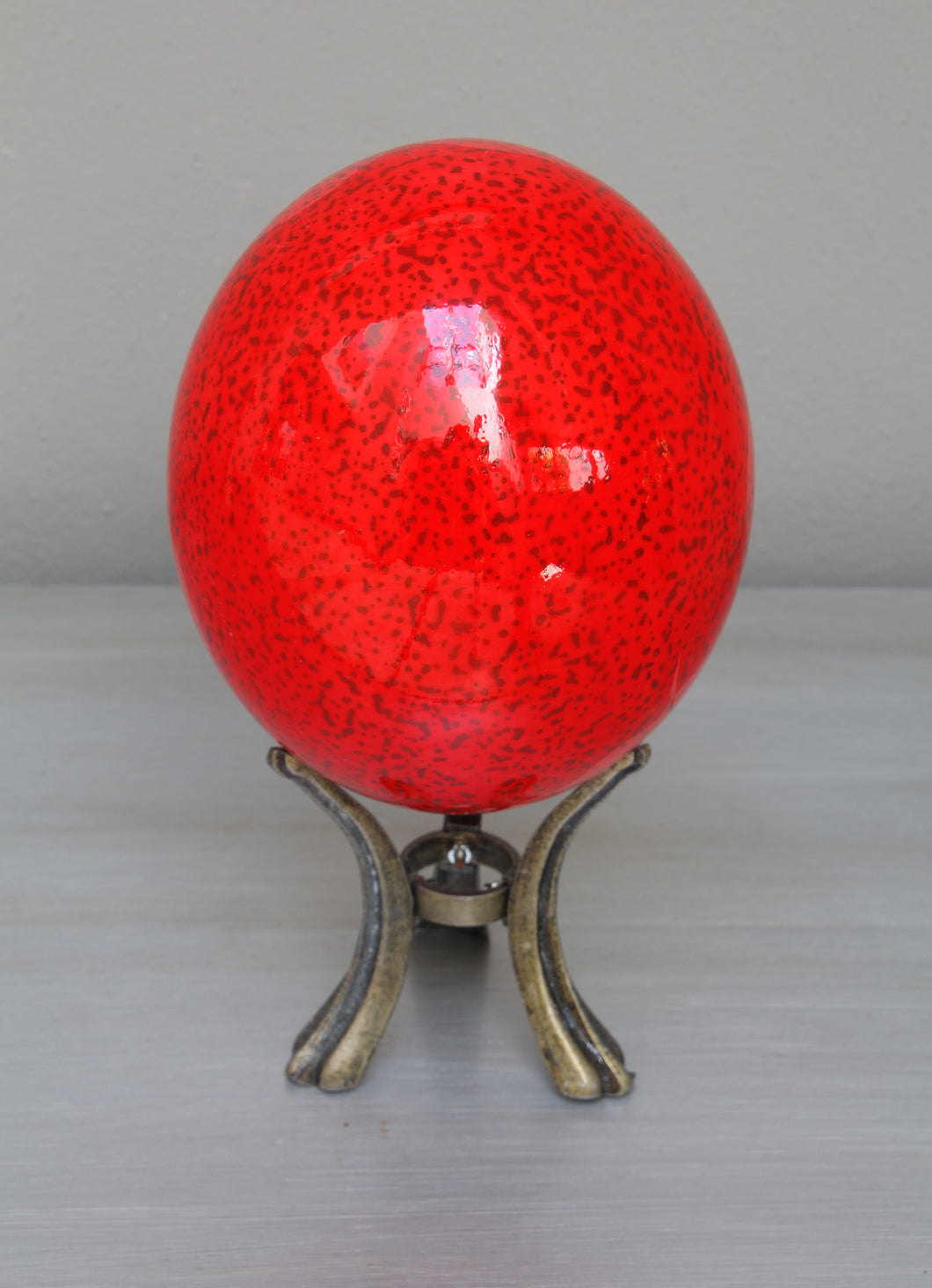 Speckled red and black ostrich egg