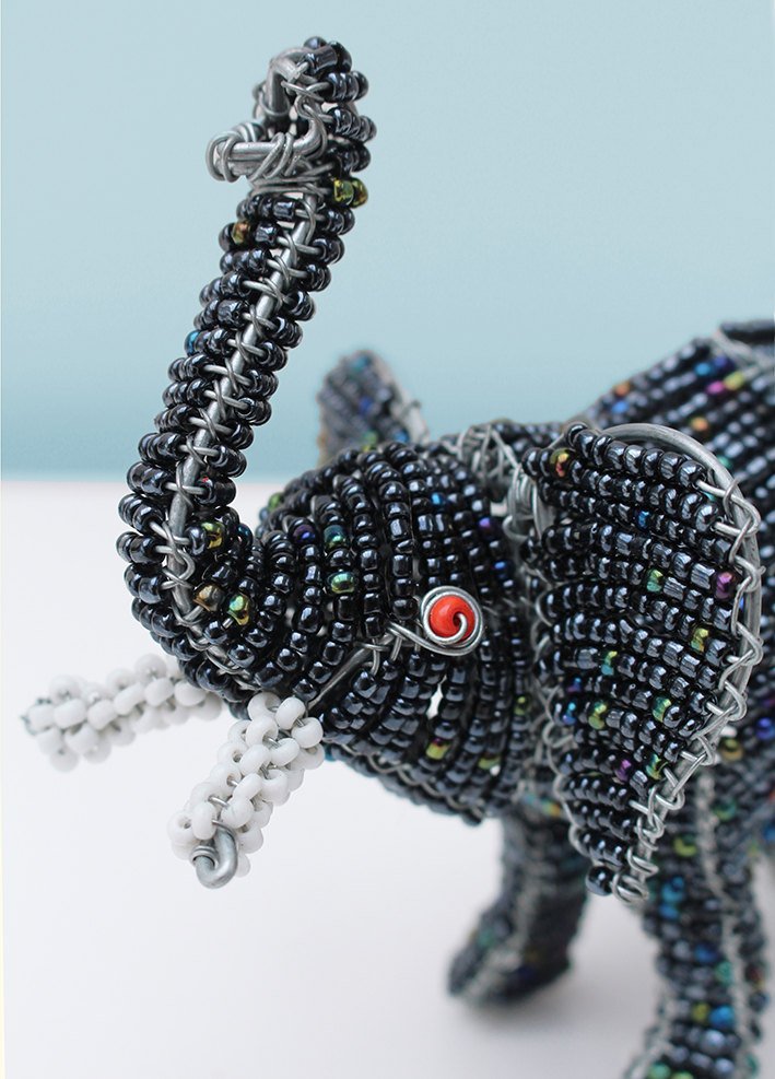 Beaded elephant with trunk up