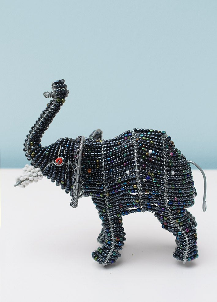 Beaded elephant with trunk up