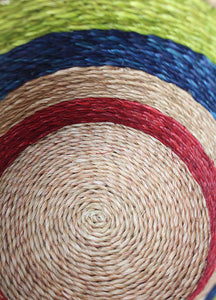Multicoloured grass-woven African basket