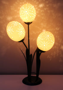 Starburst etched ostrich eggshell set on a flower lamp stand